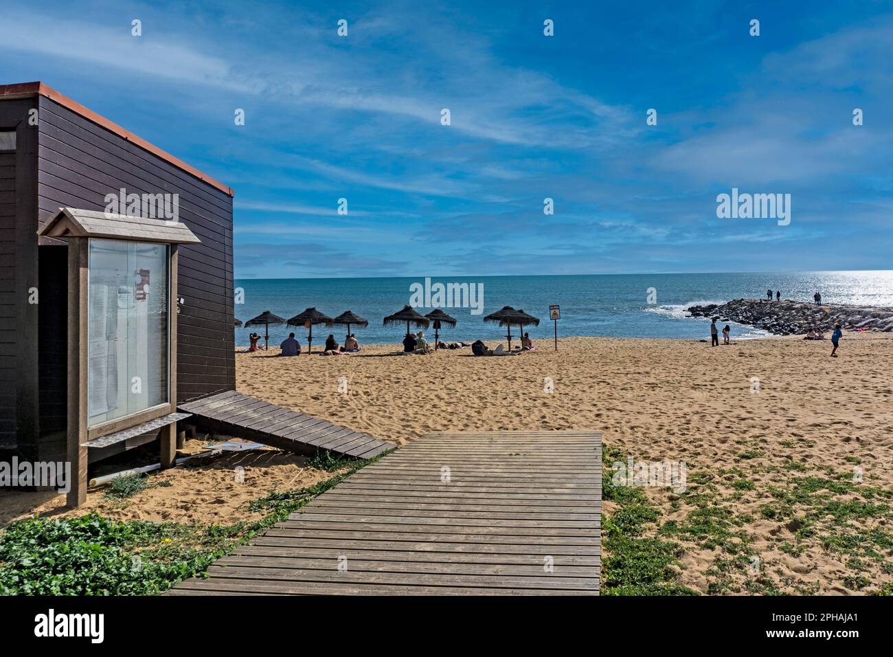 People enjoying the sunshine, in early March, in Quarteira, Portugal. Stock Photo