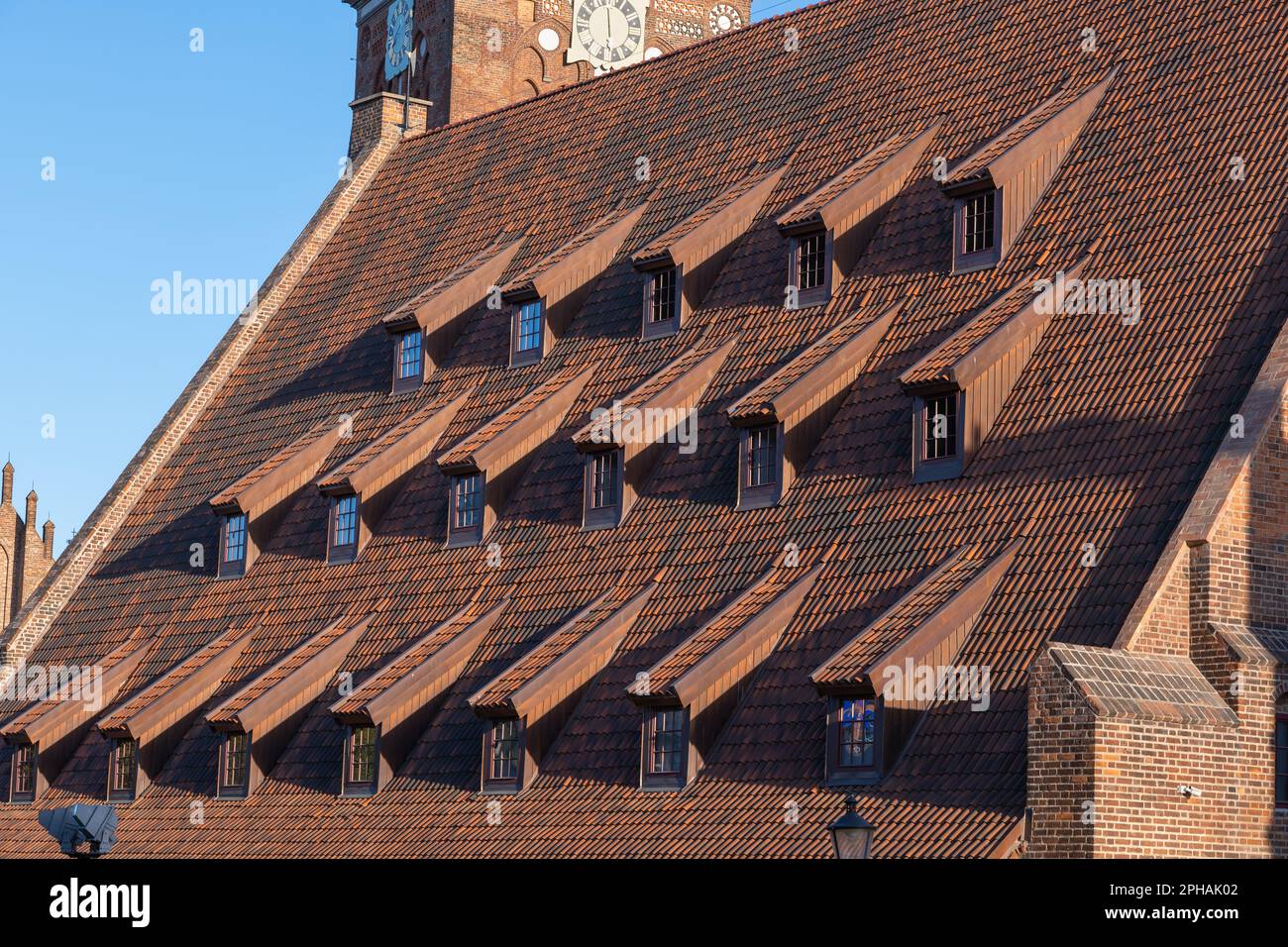 Roof of the Great Mill in Gdansk, Poland. Massive tiled roof with row of protruding windows on