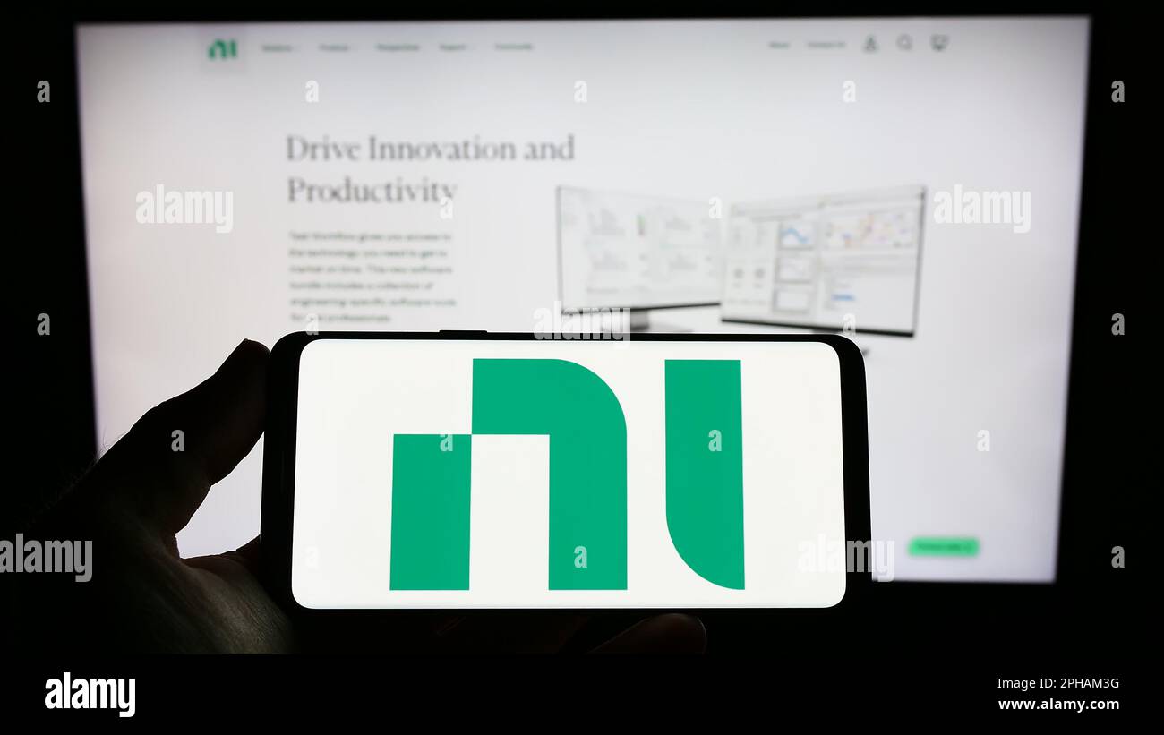 Person holding smartphone with logo of company National Instruments ...