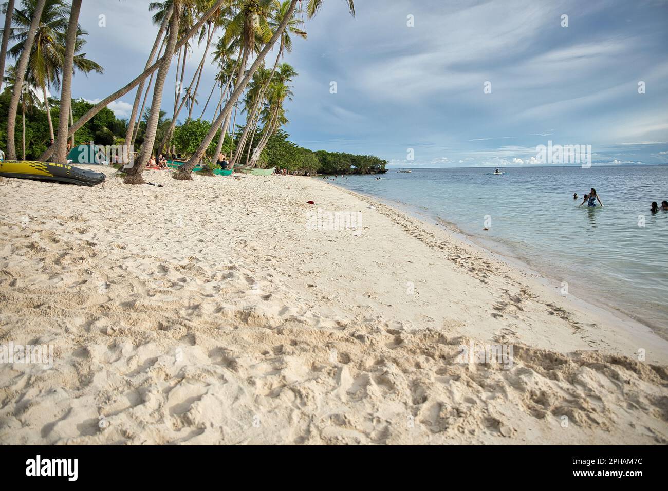 Dreamlike idyllic beach of Siquijor in the Philippines with palm trees along the beach. Stock Photo