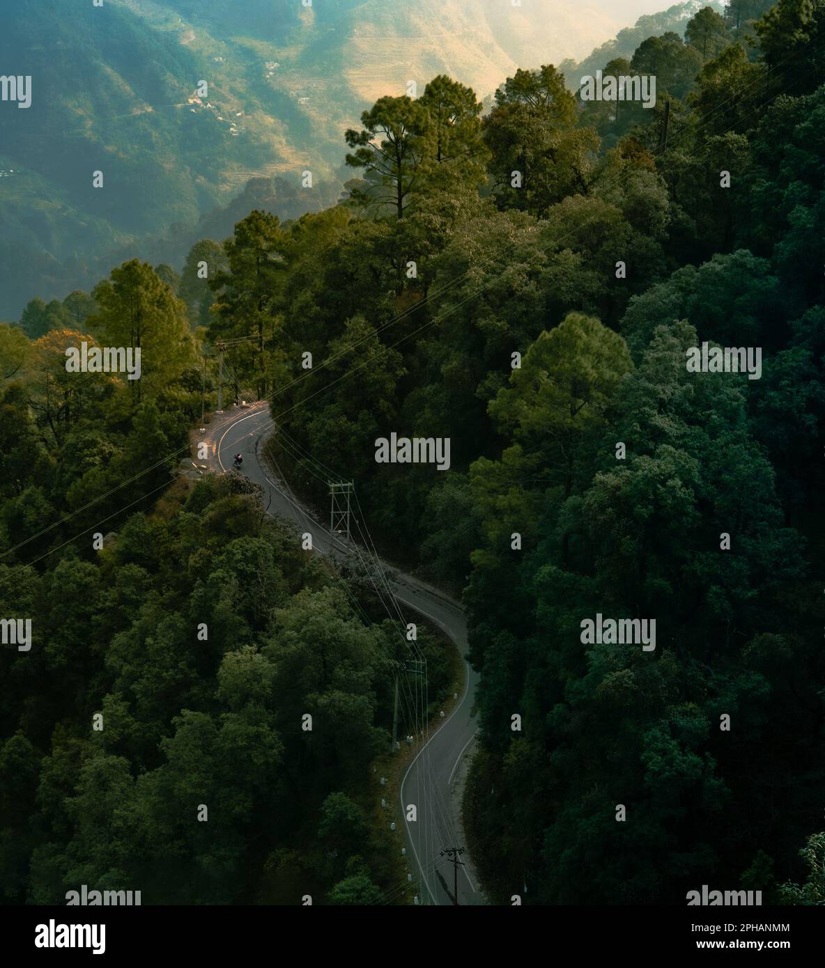 An idyllic landscape featuring a winding road snaking its way down a