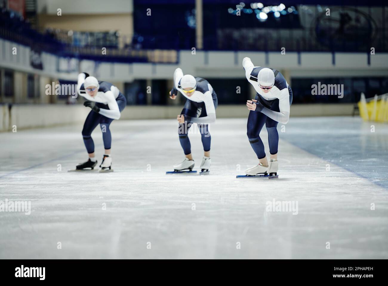 Front view of group of young sportsmen in uniform bending forwards