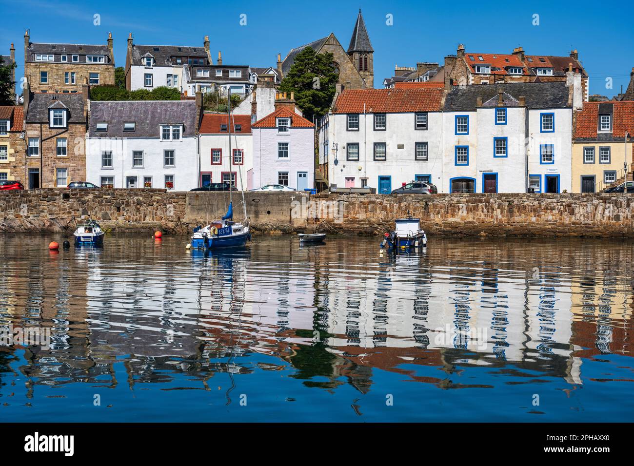 Reflections of seafront houses at St Monans harbour in East Neuk of