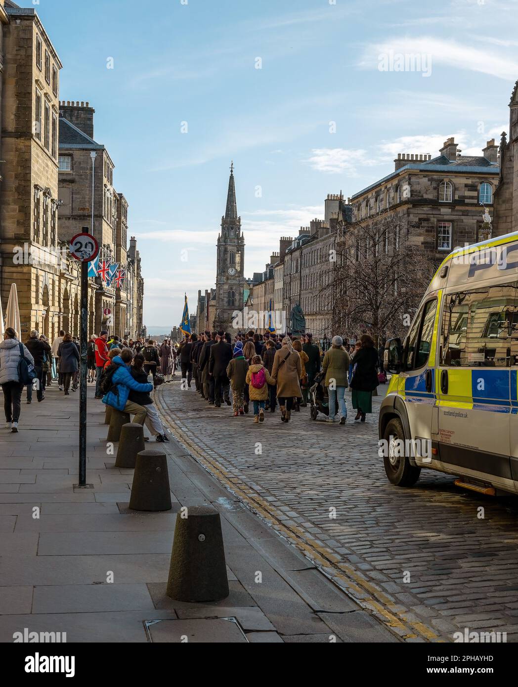Pipe Band marching down the Royal Mile with a police escort Edinburgh