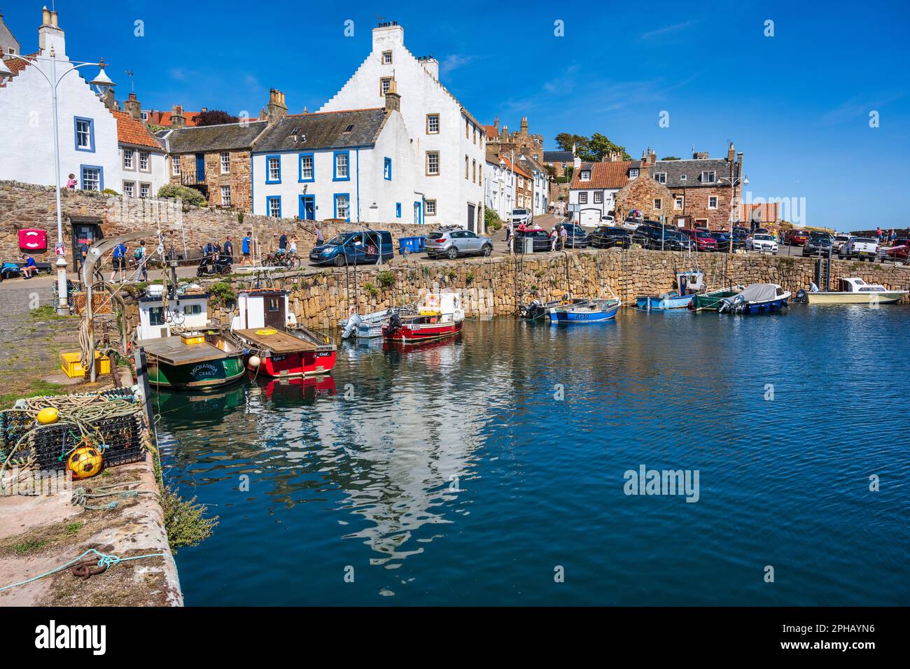 Colourful boats moored in harbour of picturesque coastal town of Crail in East Neuk of Fife, Scotland, UK Stock Photo