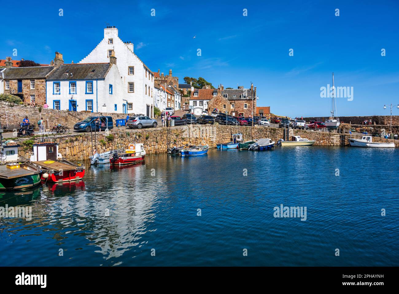 Colourful boats moored in harbour of picturesque coastal town of Crail in East Neuk of Fife, Scotland, UK Stock Photo