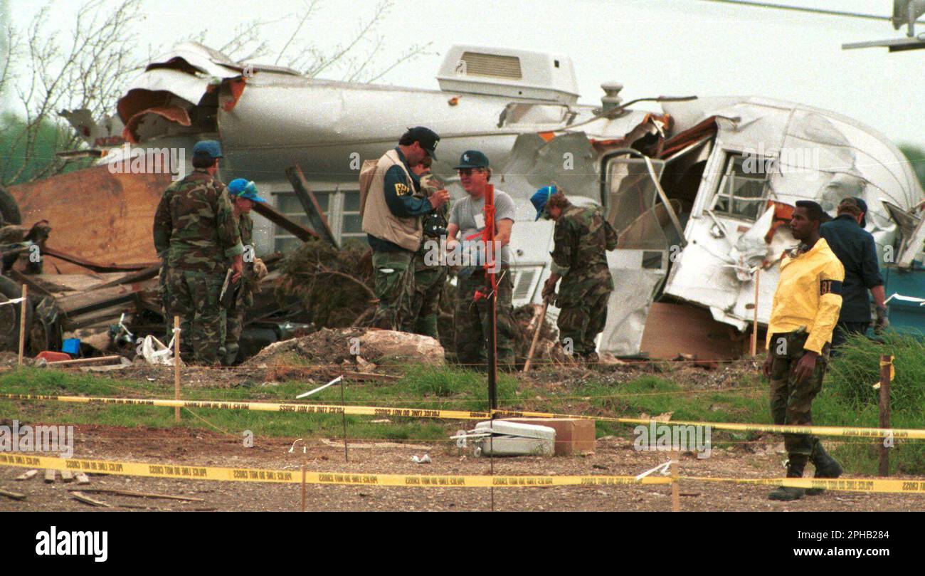 Waco, Texas USA, April 21, 1993: Federal and state law enforcement agents investigate the scene at the Branch Davidian compound two days after a devastating fire killed 76 members holed up at the religious cult's property and ended a 51-day standoff with federal law enforcement agencies. ©Bob Daemmrich Stock Photo