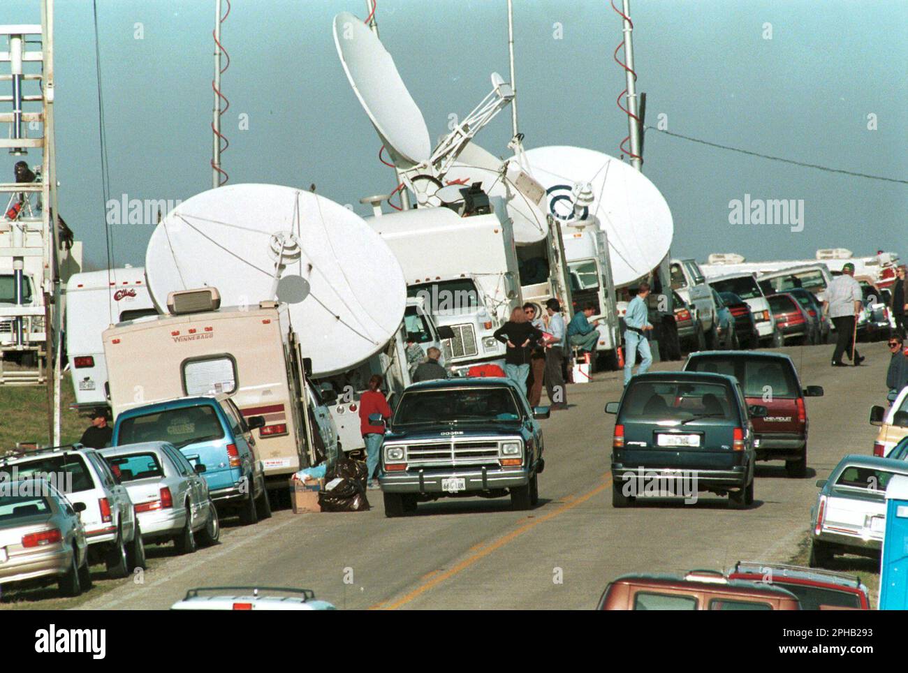 Waco Texas USA, March 1993: Television network satellite trucks and other vehicles crowd the two-lane rural county road to the entrance to the Branch Davidian compound midway through the 51-day standoff between members of the religious group and federal and state law enforcement agencies. The ongoing siege of the Mount Carmel property quickly became national news and a flashpoint among those who criticized the government for persecution and over-reach. ©Bob Daemmrich Stock Photo