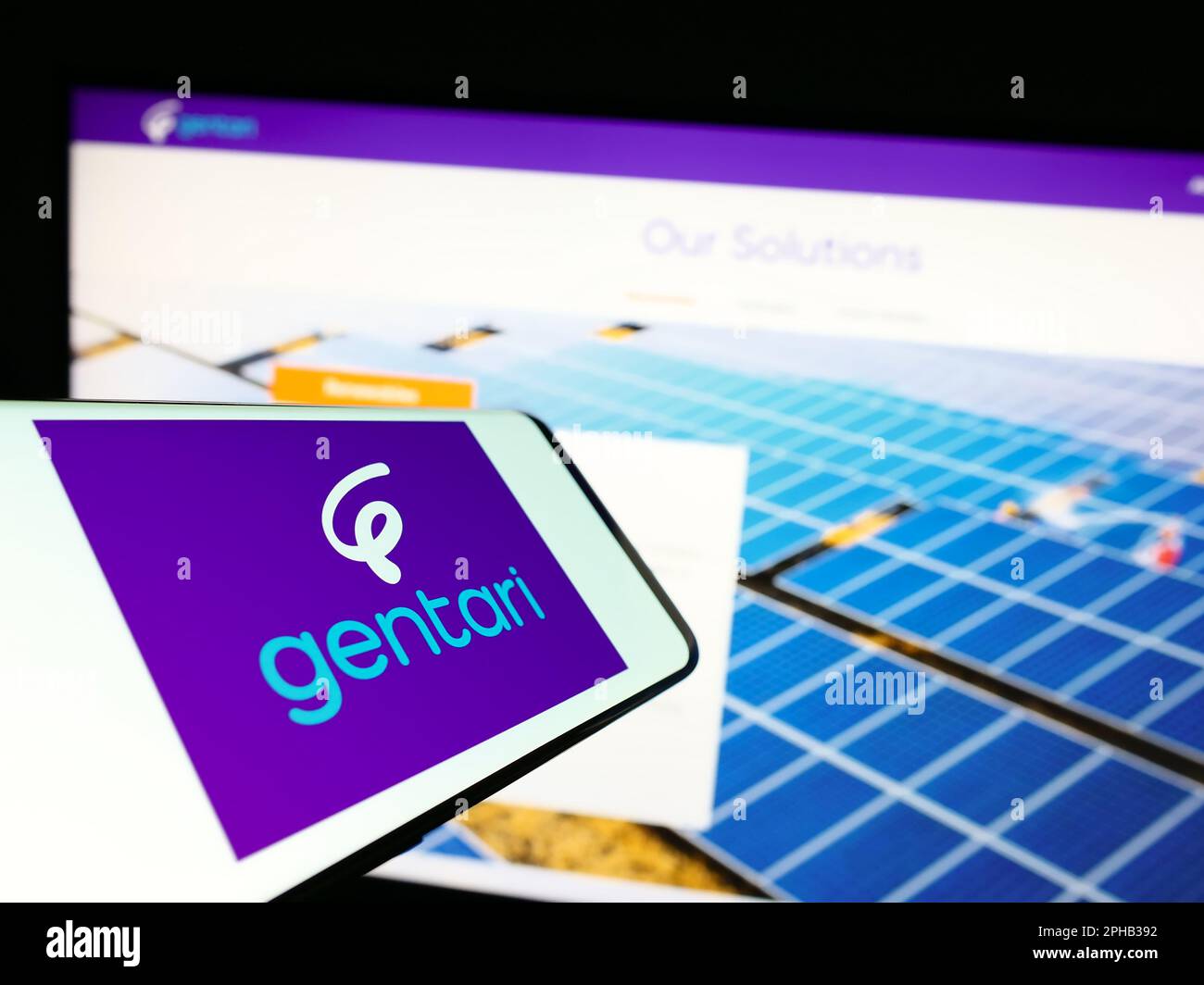 Mobile phone with logo of Malaysian energy company Gentari Sdn. Bhd. on screen in front of website. Focus on center-right of phone display. Stock Photo