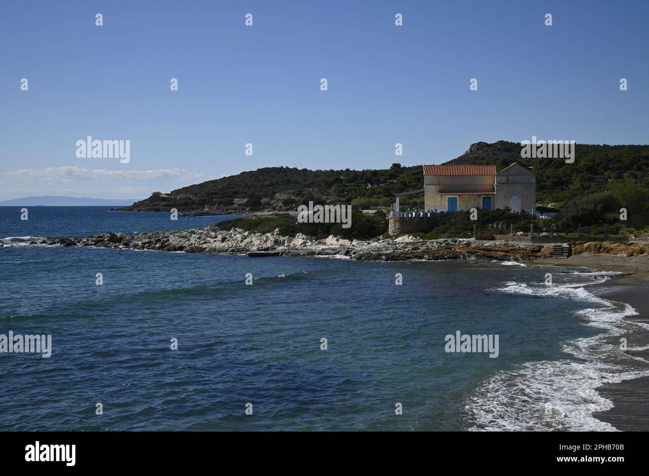 Landscape with scenic view of a traditional summer house on the coastline of Sounion in Attica, Greece. Stock Photo