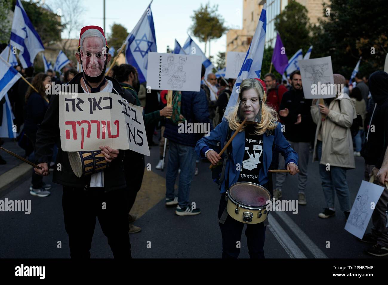 People wear cutouts depicting Israeli Prime Minster Benjamin Netanyahu ...