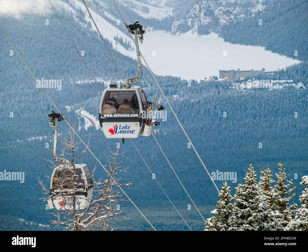 Ski gondolas with distant view of Chateau Lake Louise, Alberta, Canada