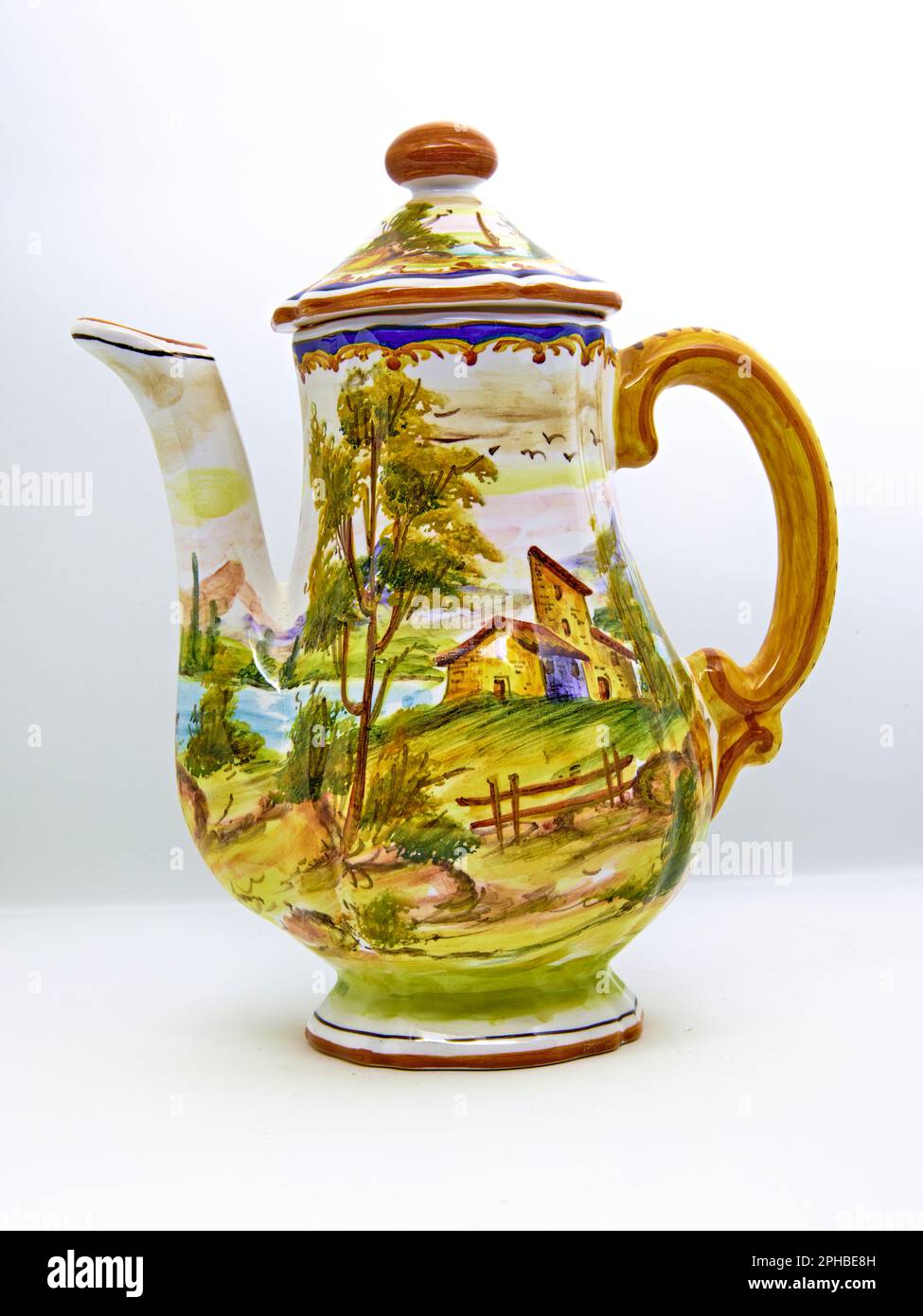 Vintage tea pot isolated on white background. With a French country scene. Made in Italy. Stock Photo