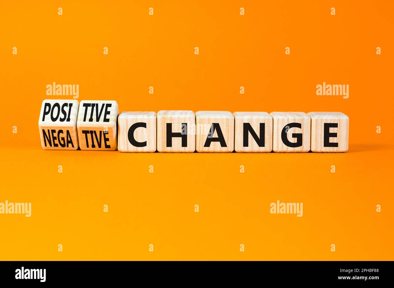 Positive or negative change symbol. Concept word Positive change Negative change on wooden cubes. Beautiful orange background. Business positive negat Stock Photo