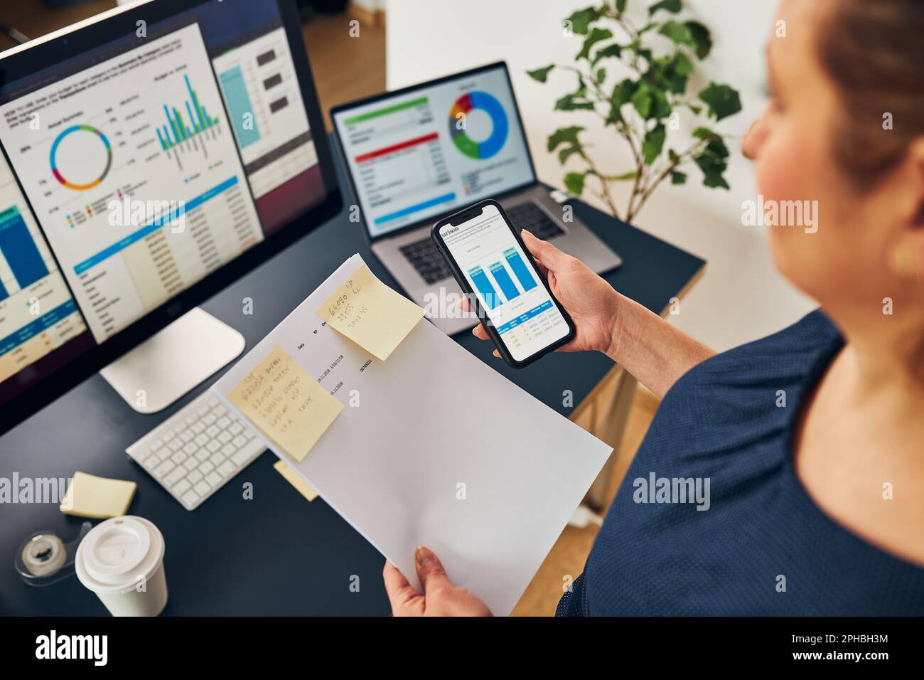 Businesswoman working with financial data on charts and tables on