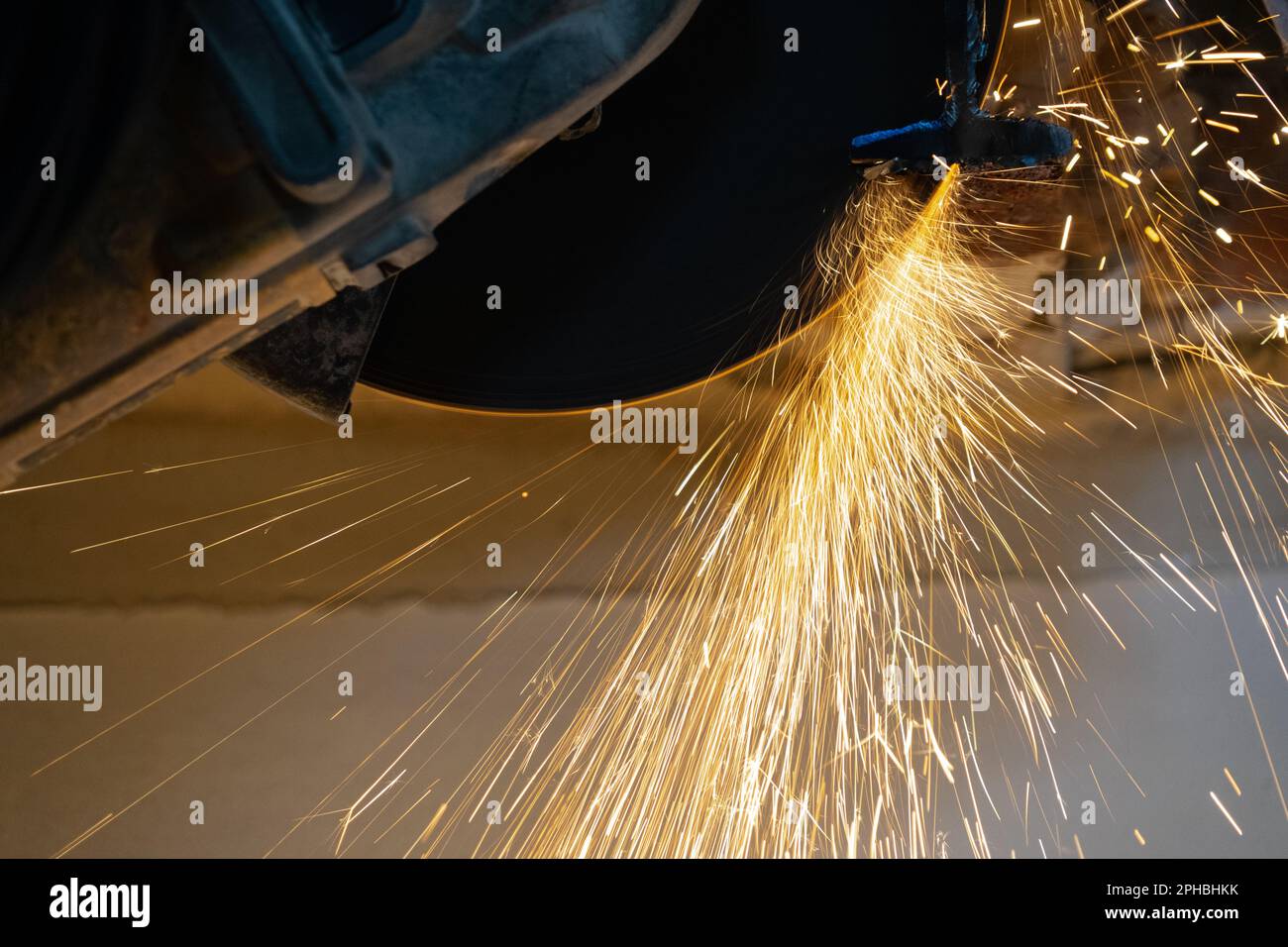 Sparks flying off the cutting disc of an angle grinder Stock Photo
