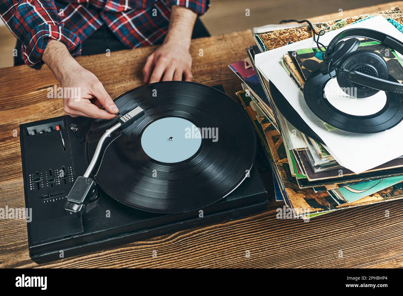 Man listening to music from vinyl record. Playing analog disk on turntable Enjoying music from old collection. Relaxing at Re Stock Photo - Alamy