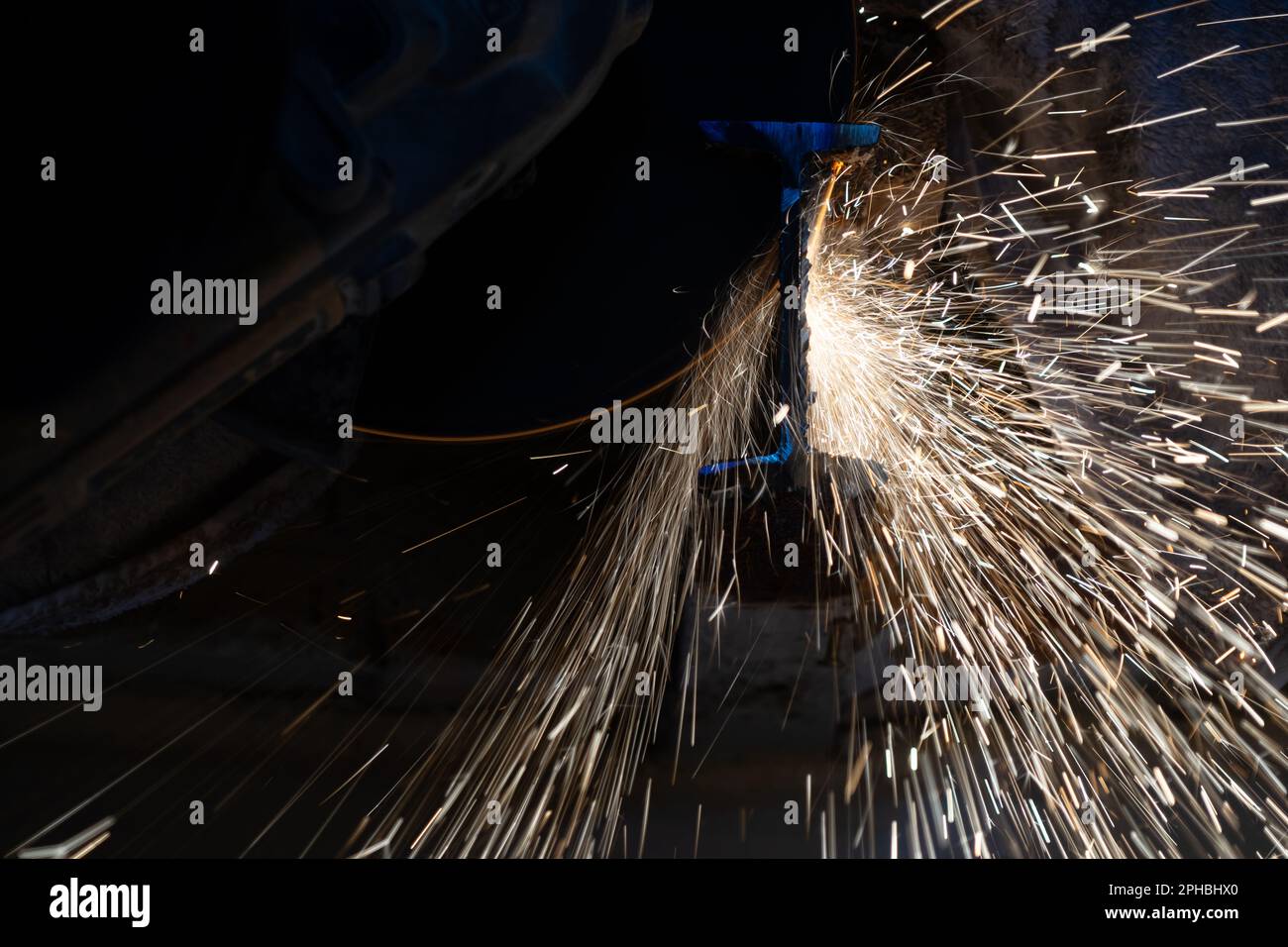 Sparks flying off the cutting disc of an angle grinder Stock Photo