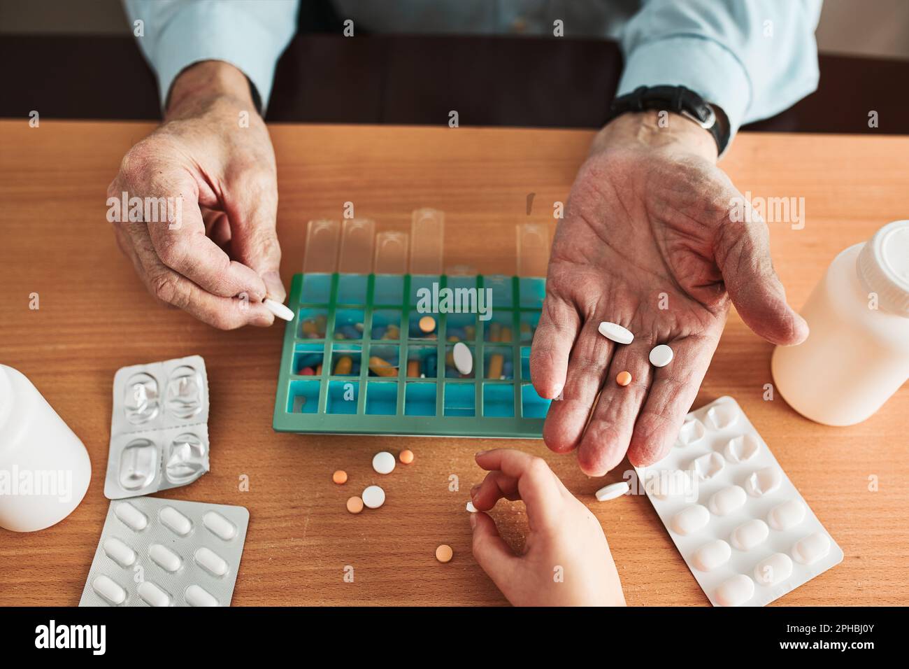Senior man organizing his medication into pill dispenser. Senior man