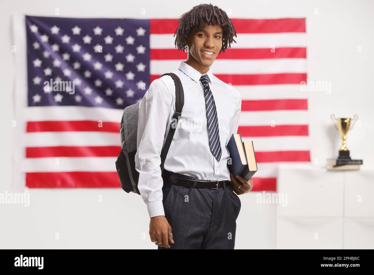 African american male student with a backpack wearing a uniform and ...
