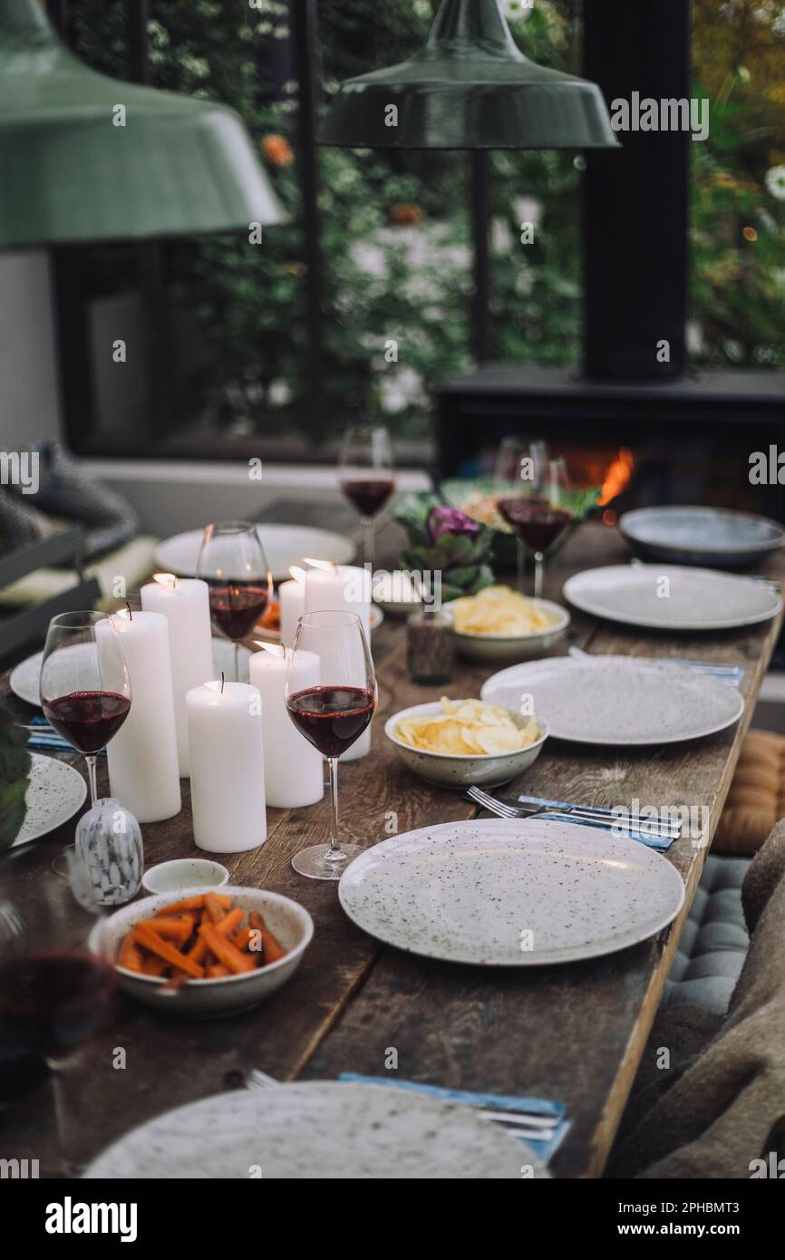 Dining table with wineglasses and plates Stock Photo