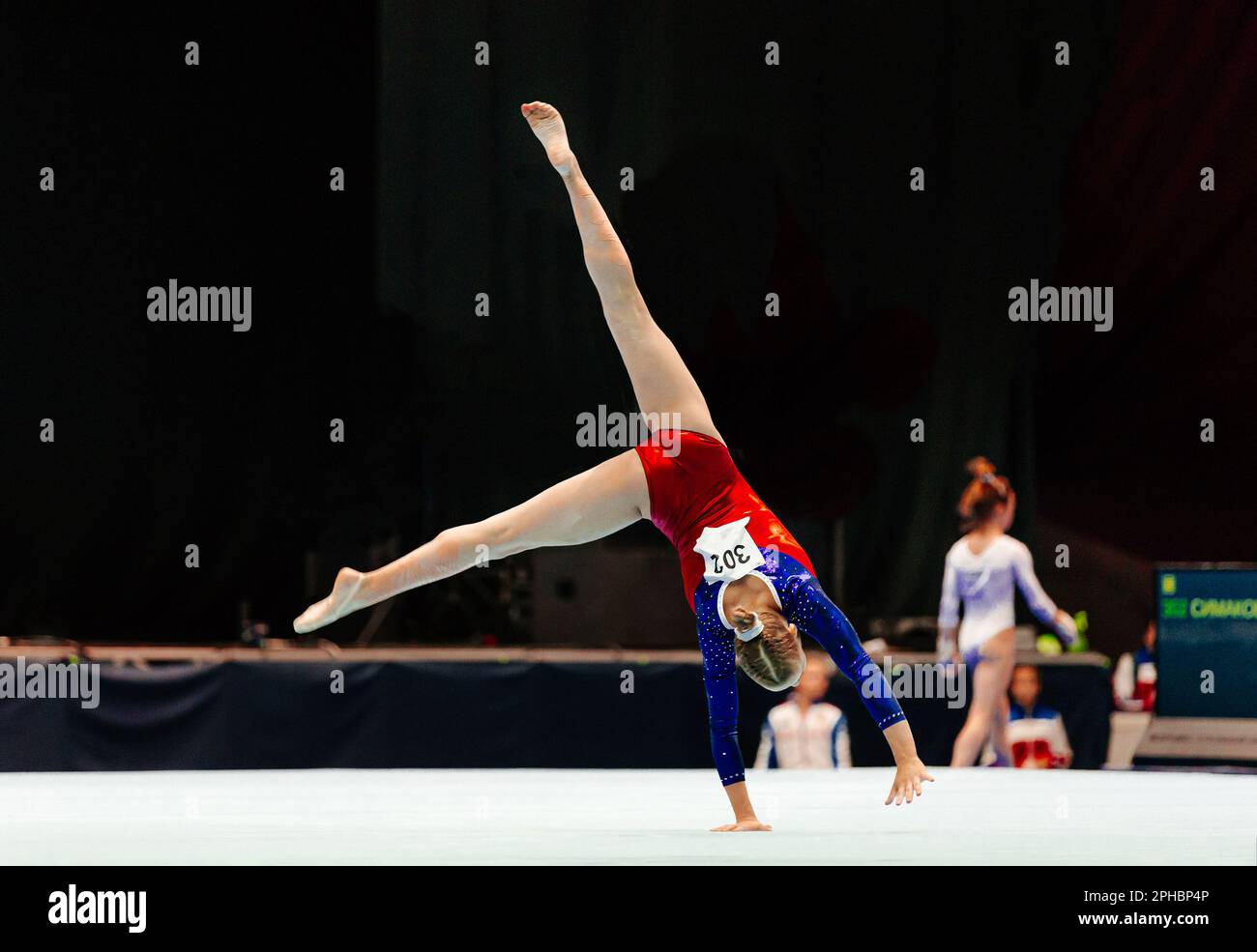 woman gymnast performing acrobatic on floor gymnastics, olympic sports