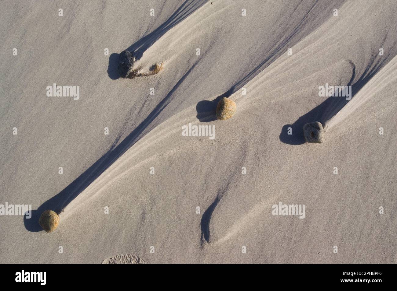 Shapes blown by the wind and surf around the pebbles on the beach of la Cinta. Siniscola, Sardinia Italy Stock Photo