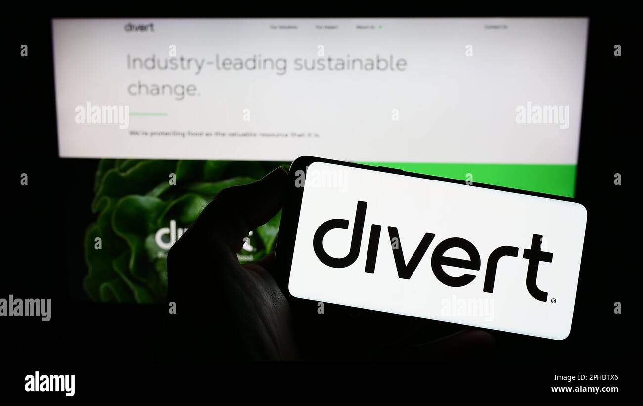 Person holding mobile phone with logo of American food technology