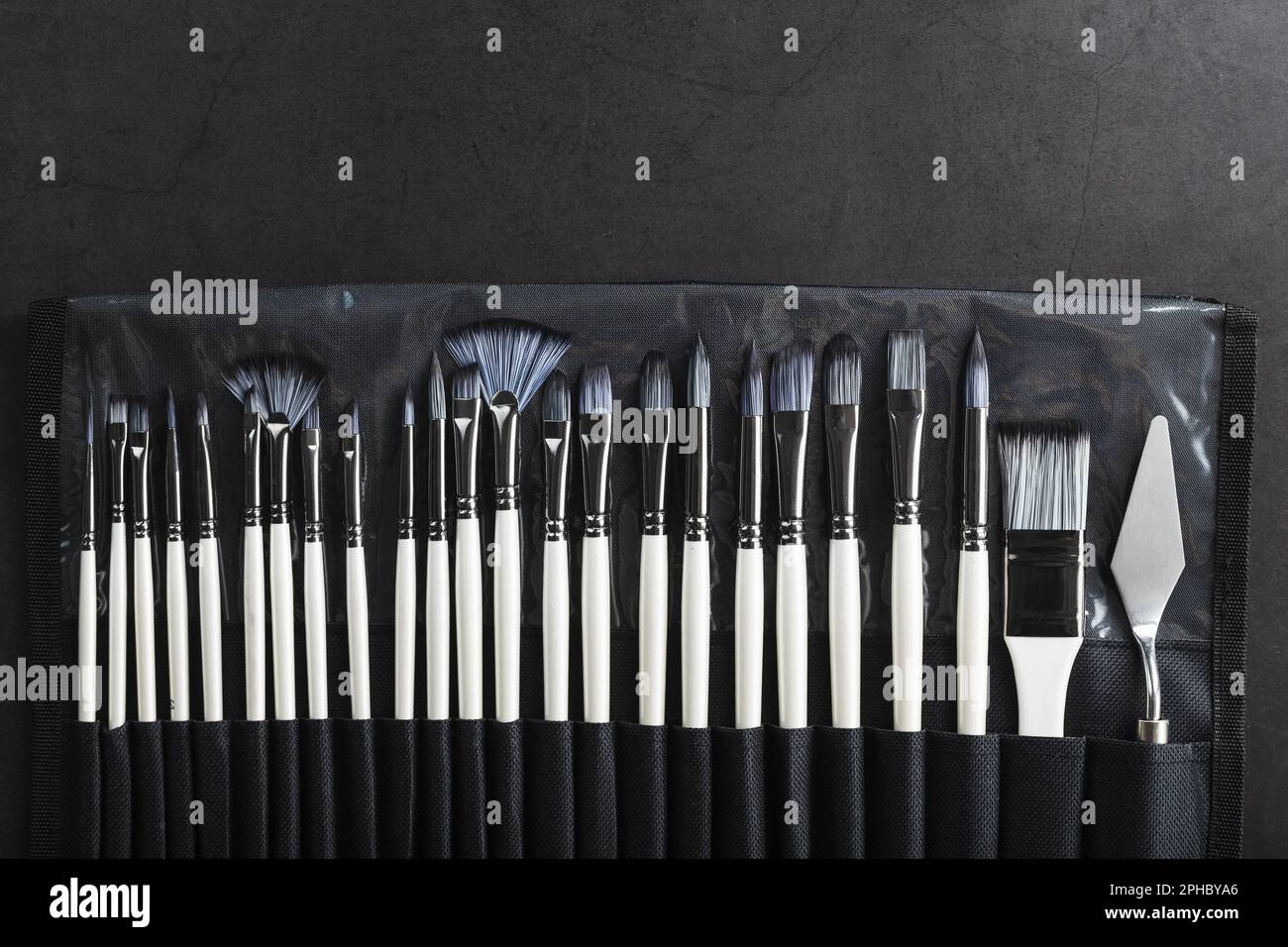 A set of art brushes for drawing on a black background, top view with free space Stock Photo