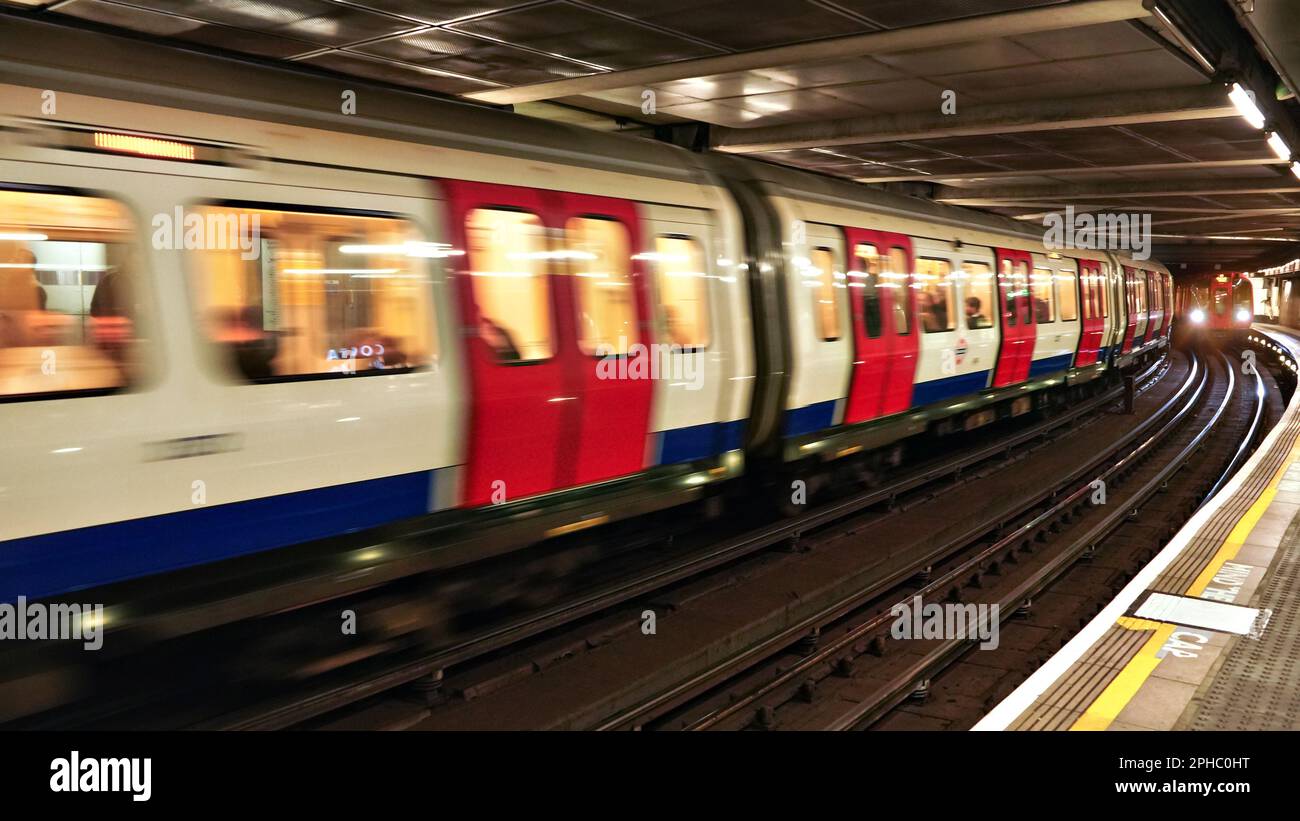 London, United Kingdom - February 01, 2019: Underground line train arriving at station, another blurred moving in opposite direction. Typical MIND THE Stock Photo