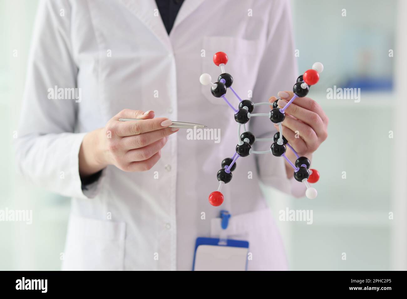 Lab assistant demonstrates molecule model close view Stock Photo