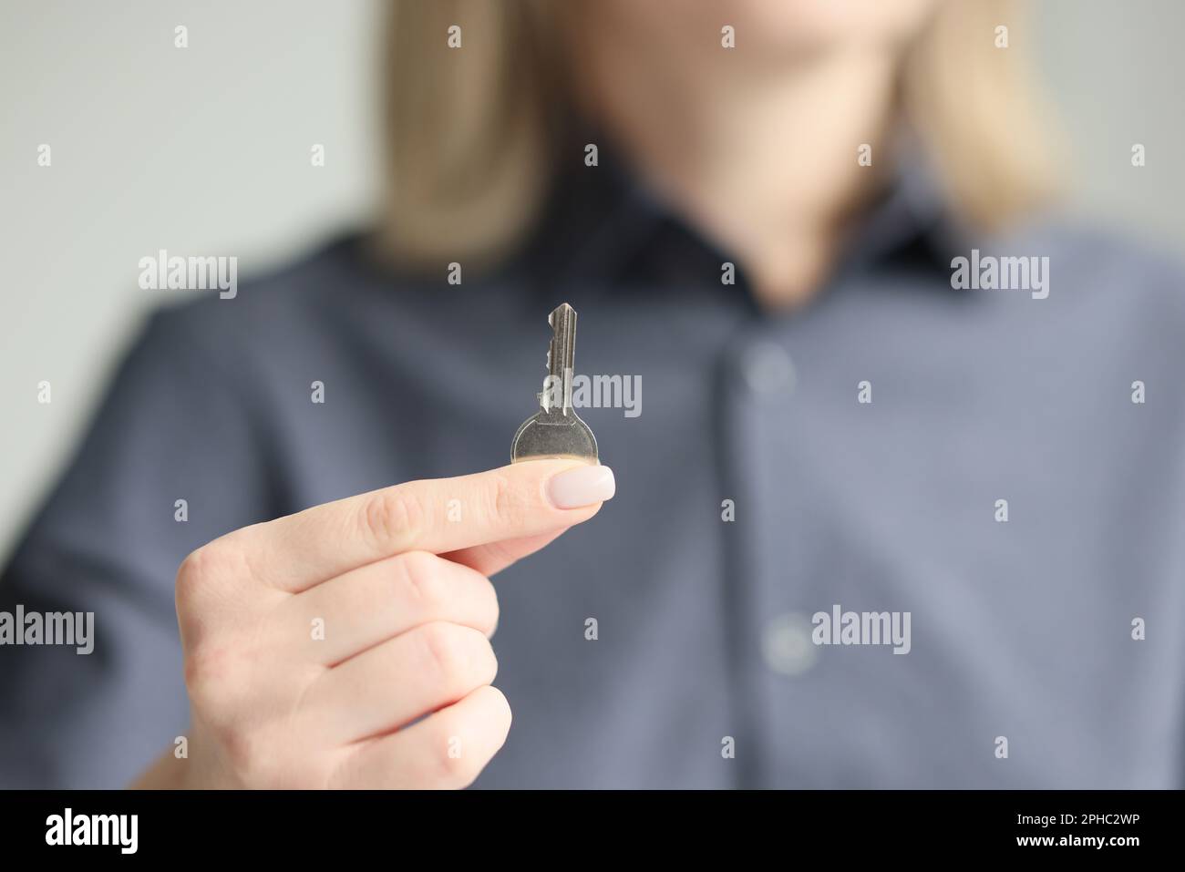 Woman shows key to just bought own apartment closeup Stock Photo