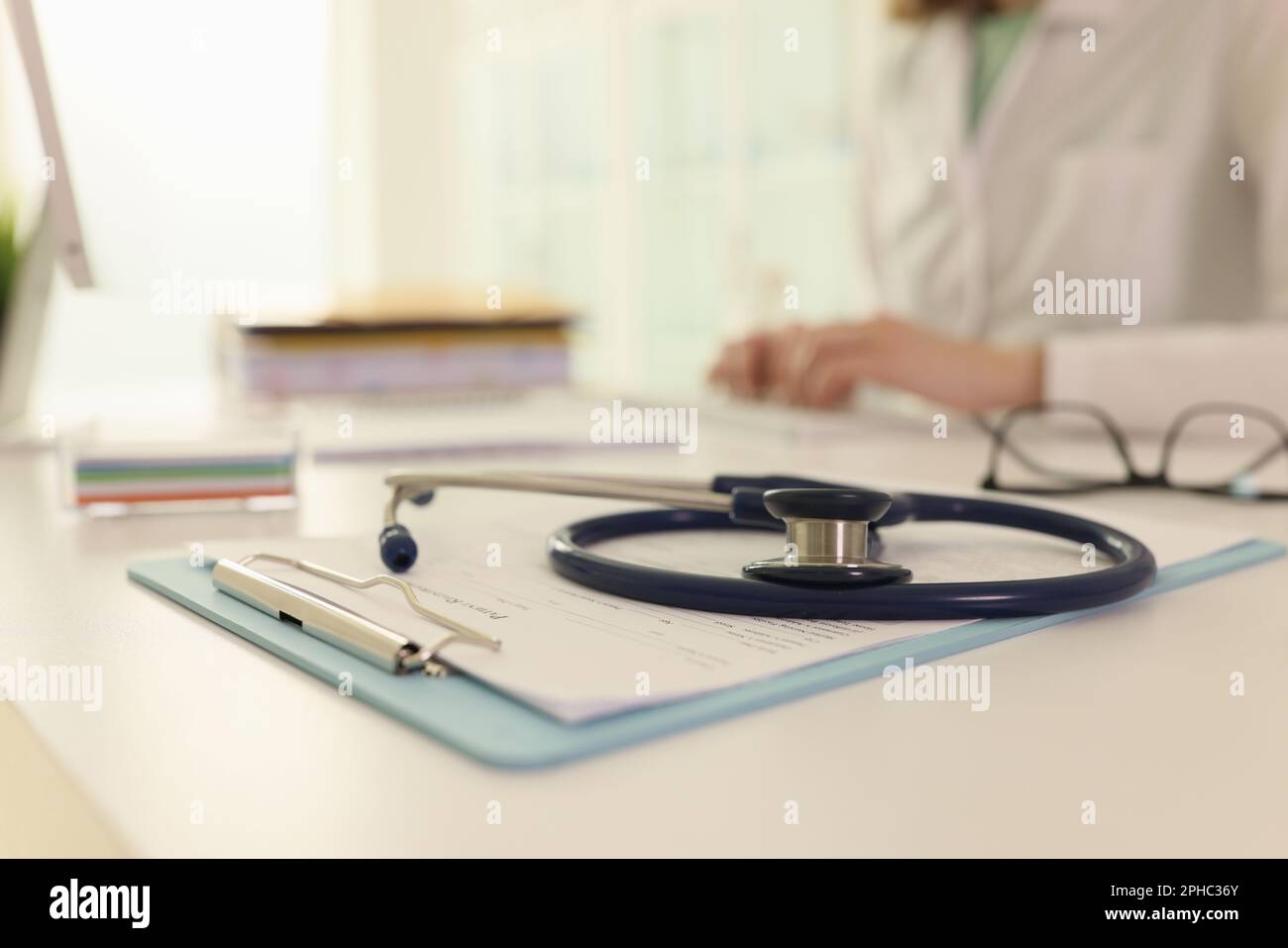 Stethoscope and medical records on doctor table in hospital Stock Photo