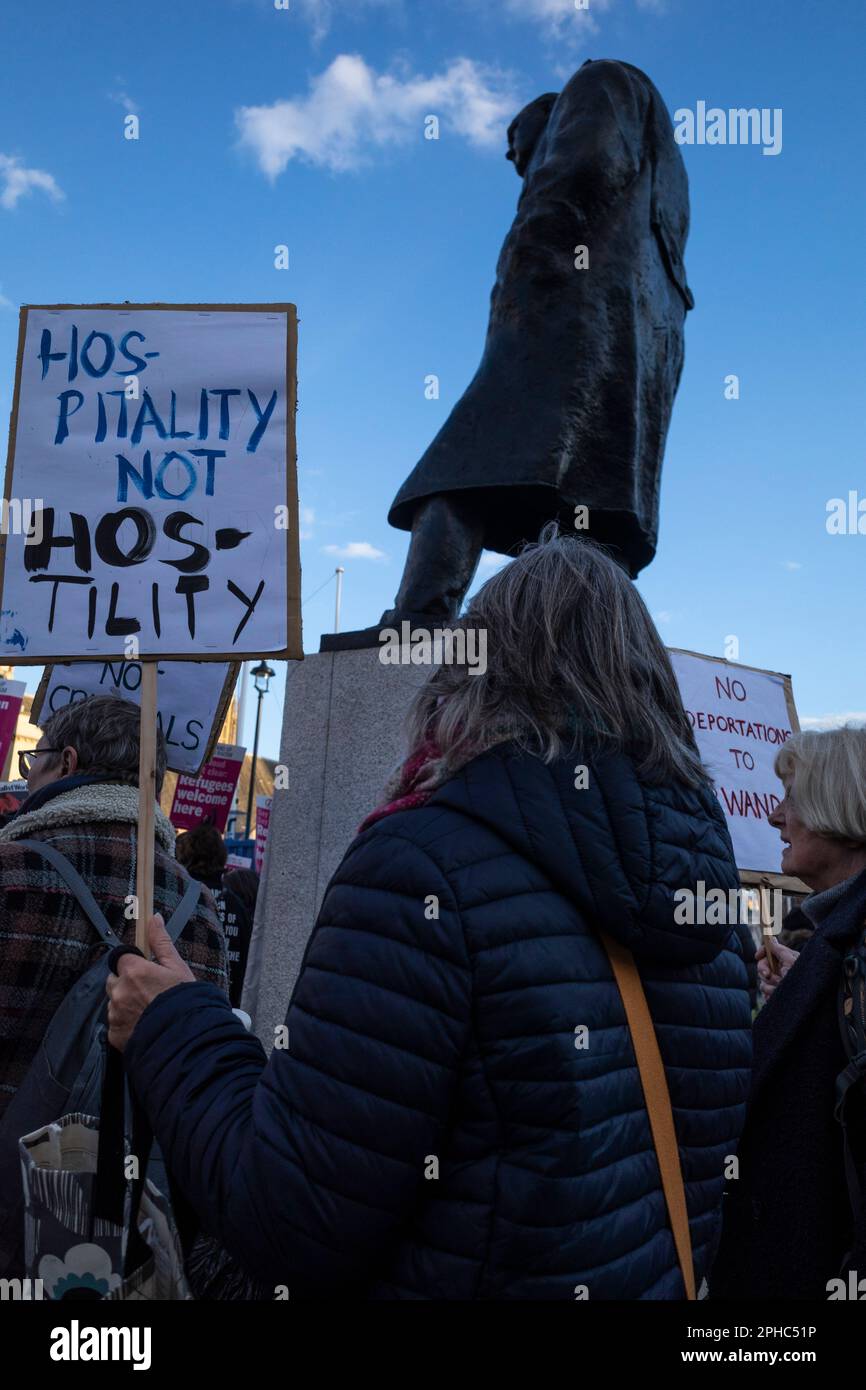 London, UK.  27 March 2023.  People by the statue of Sir Winston Churchill at a rally in Parliament Square opposing the The Illegal Migration Bill which is being debated by MPs in the House of Commons.  Credit: Stephen Chung / Alamy Live News Stock Photo