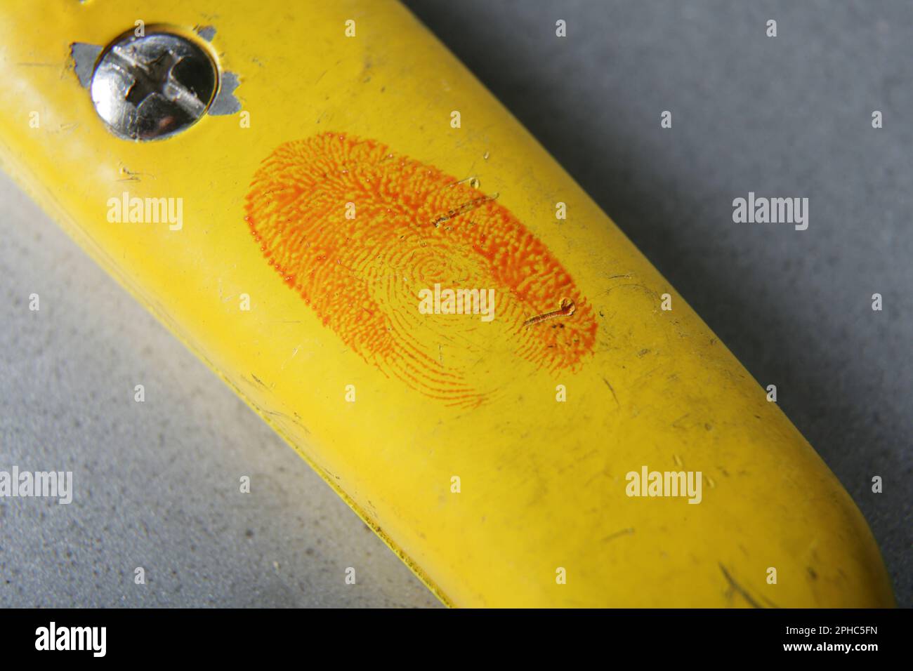 A bloody fingerprint on a craft knife Stock Photo