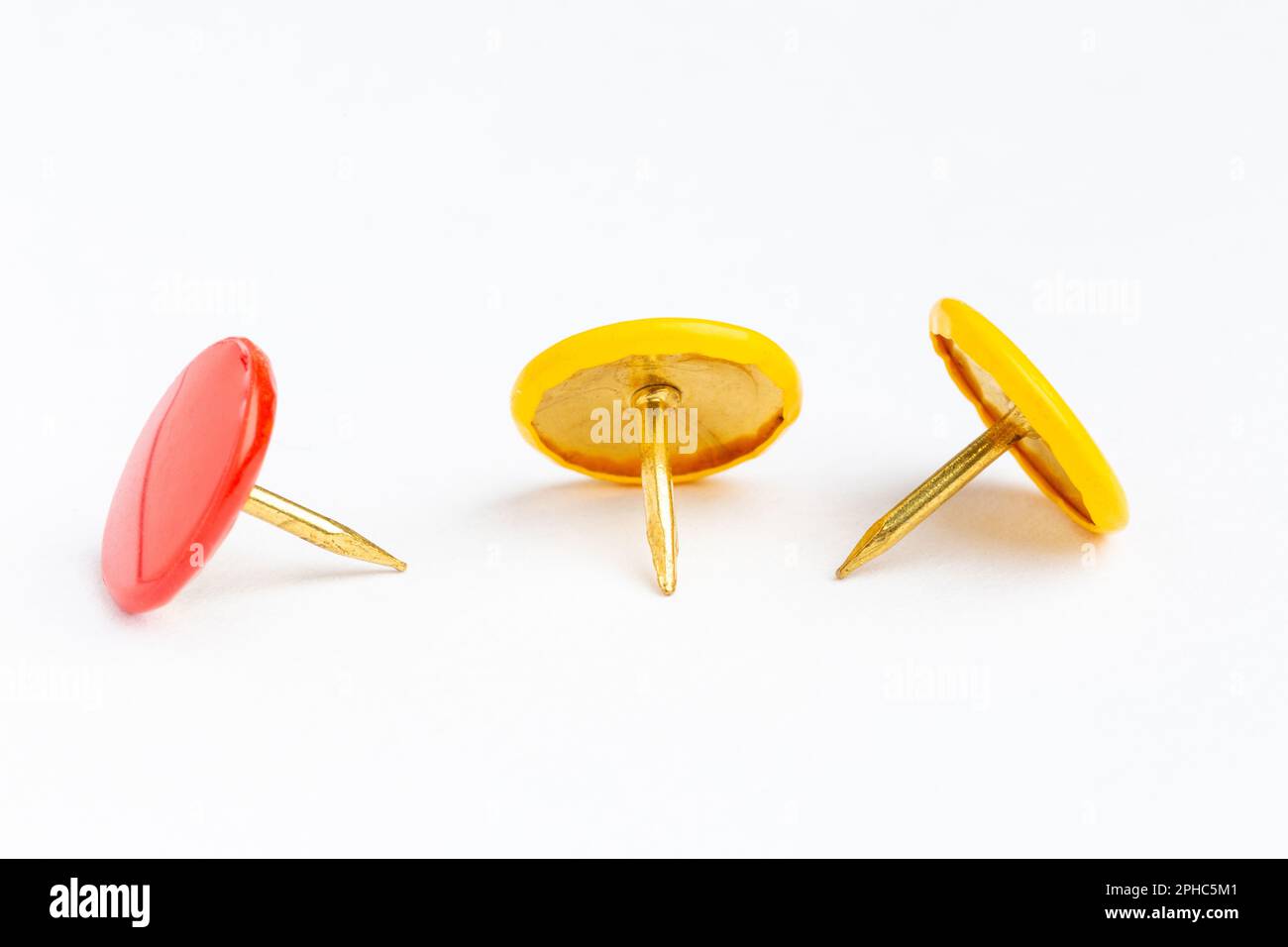 Three drawing pins on a white background. Stock Photo