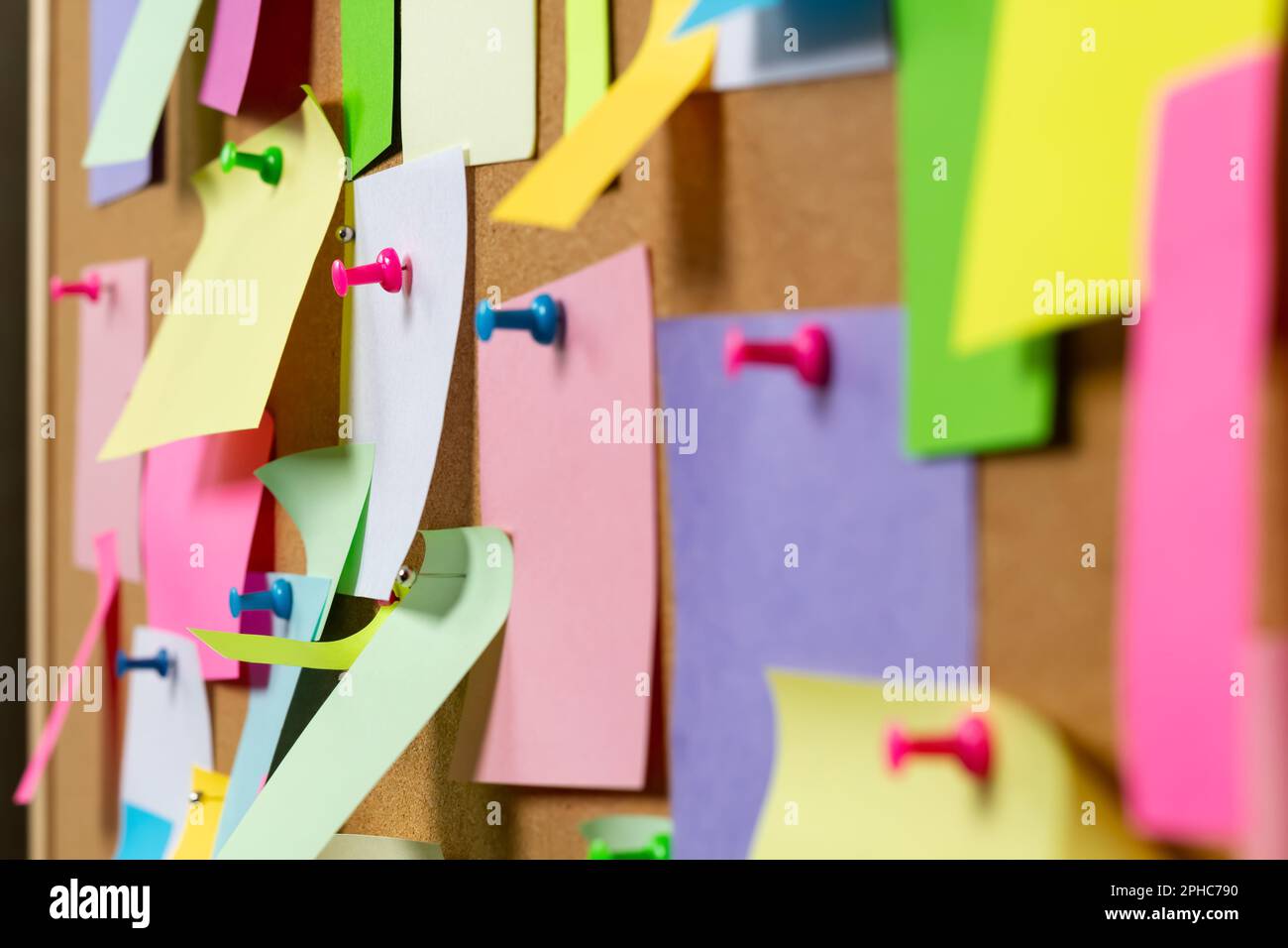 Post blank stickers on cork bulletin board. Concept of business notes. Stock Photo