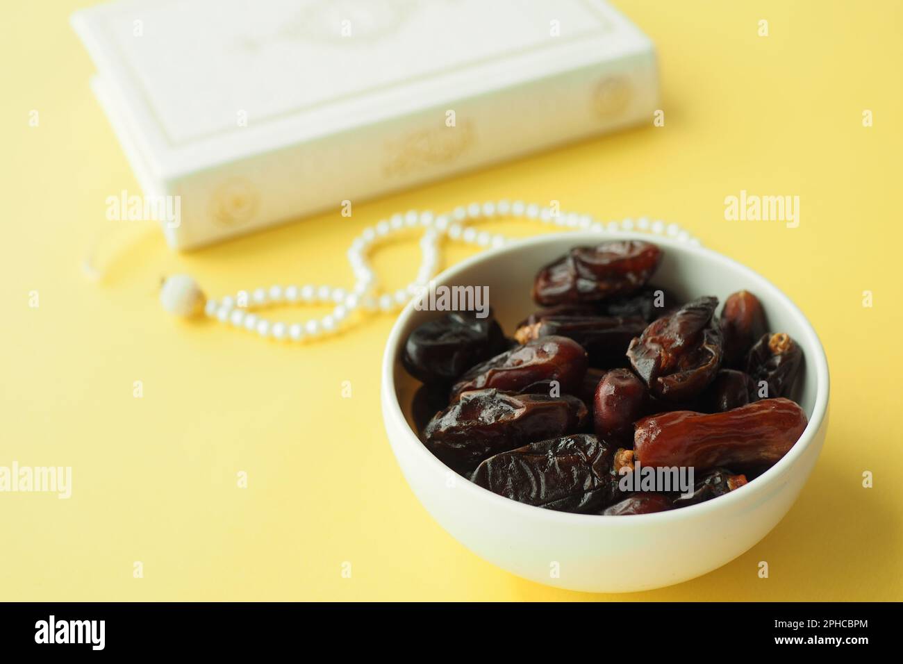date fruit and Holy Quran on table Stock Photo Alamy