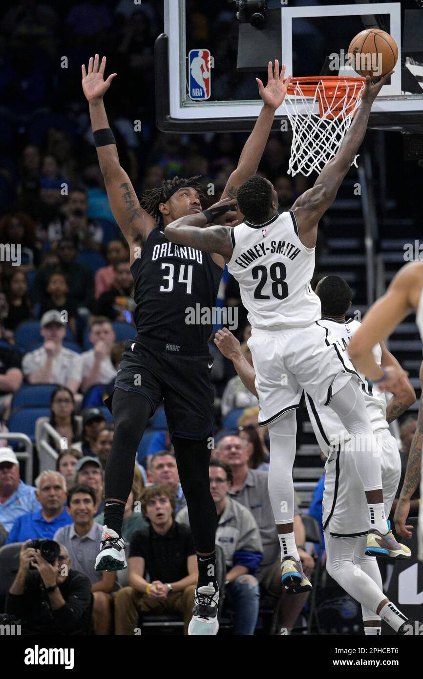 Brooklyn Nets forward Dorian Finney-Smith (28) shoots a 3-pointer during  the first half of an NBA basketball game against the Orlando Magic, Sunday,  March 26, 2023, in Orlando, Fla. (AP Photo/Phelan M.