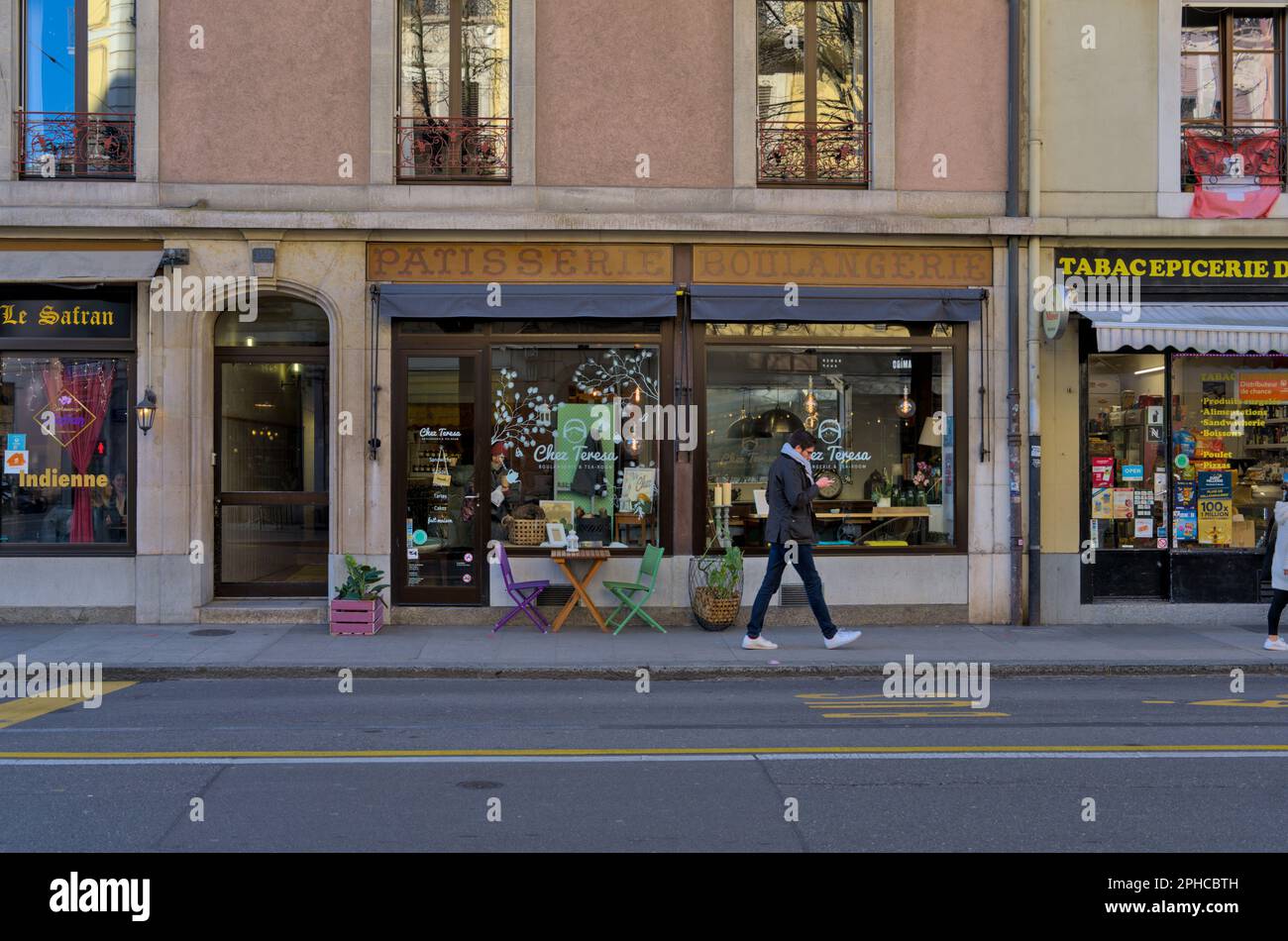 Bakery and pastry shop with colorful chairs outside during the daytime