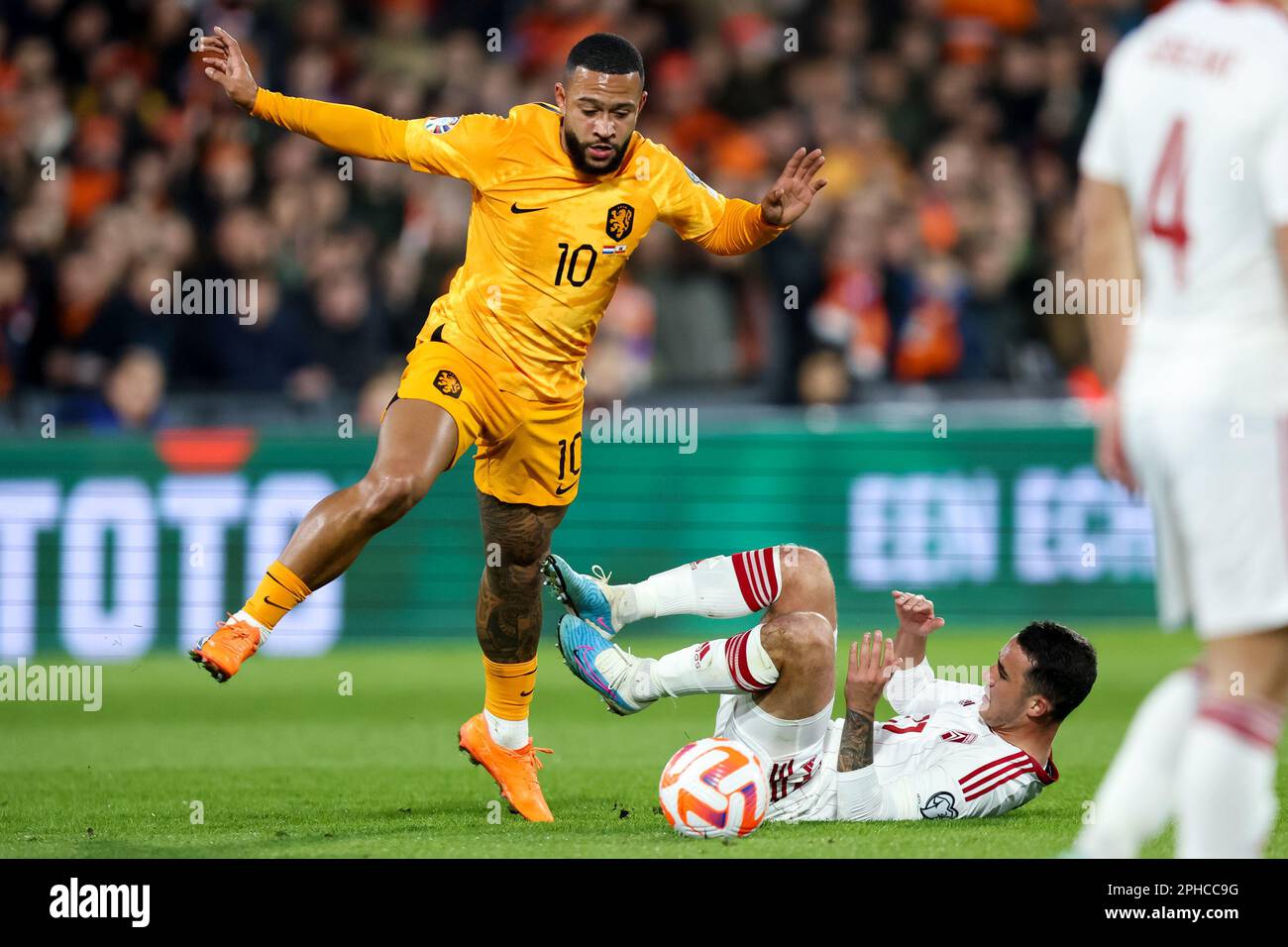 Rotterdam, Netherlands. 27th Mar, 2023. ROTTERDAM, NETHERLANDS - MARCH 27: Memphis Depay of the Netherlands and Kian Ronan of Gibraltar battle for possession during the UEFA EURO 2024 Qualifying Round Group B match between Netherlands and Gibraltar at Stadion Feijenoord on March 27, 2023 in Rotterdam, Netherlands (Photo by Peter Lous/Orange Pictures) Credit: Orange Pics BV/Alamy Live News Stock Photo