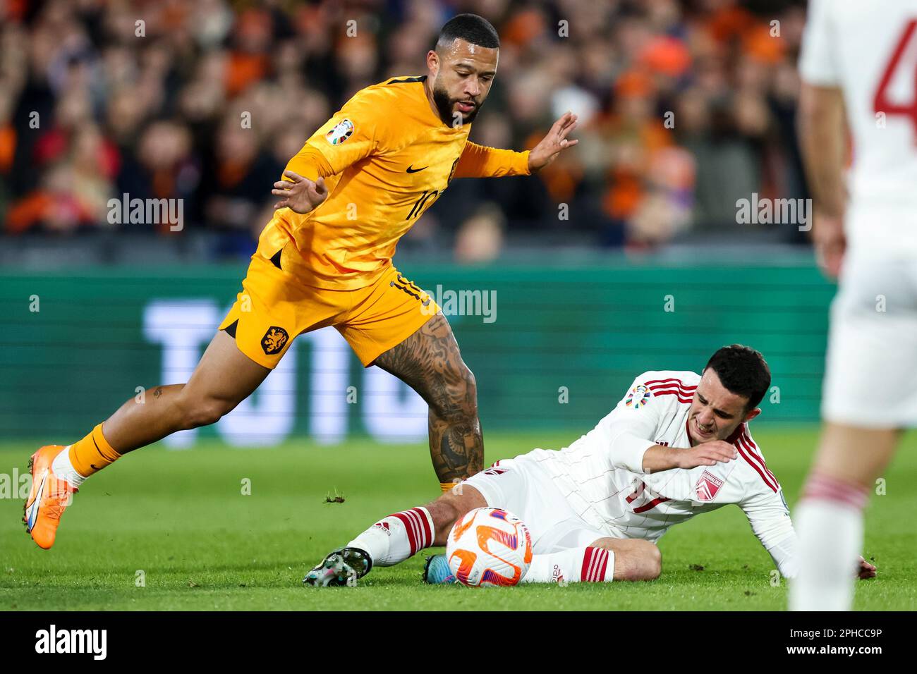 Rotterdam, Netherlands. 27th Mar, 2023. ROTTERDAM, NETHERLANDS - MARCH 27: Memphis Depay of the Netherlands and Kian Ronan of Gibraltar battle for possession during the UEFA EURO 2024 Qualifying Round Group B match between Netherlands and Gibraltar at Stadion Feijenoord on March 27, 2023 in Rotterdam, Netherlands (Photo by Peter Lous/Orange Pictures) Credit: Orange Pics BV/Alamy Live News Stock Photo