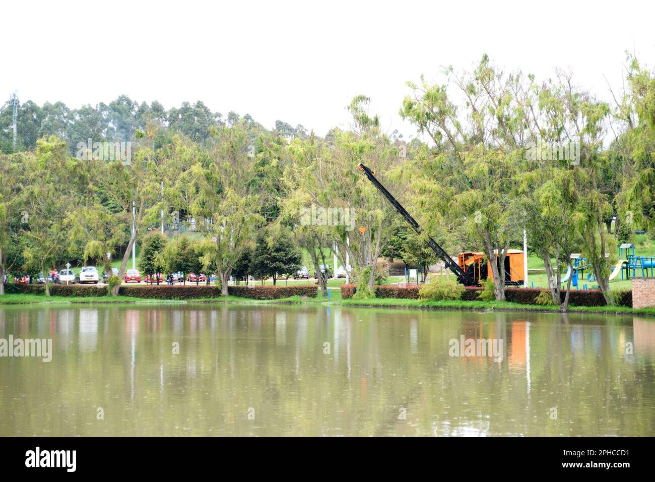 January 22, 2023, Sopo, Colombia: lake of the Sopo Bridge Park. On the bank, an old steam shovel used for the construction and maintenance of irrigati Stock Photo