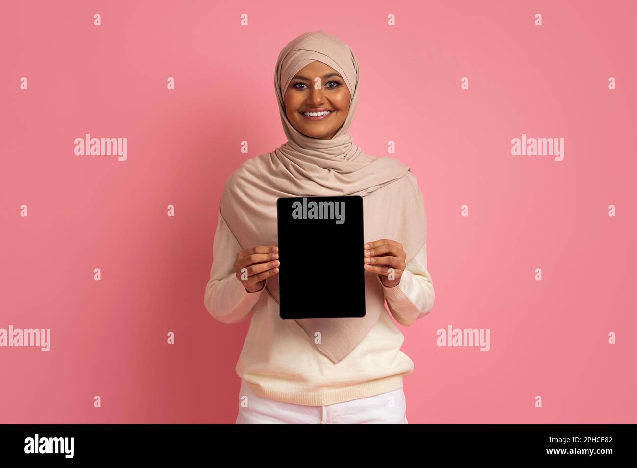 Smiling Muslim Woman In Hijab Holding Digital Tablet With Blank Black ...