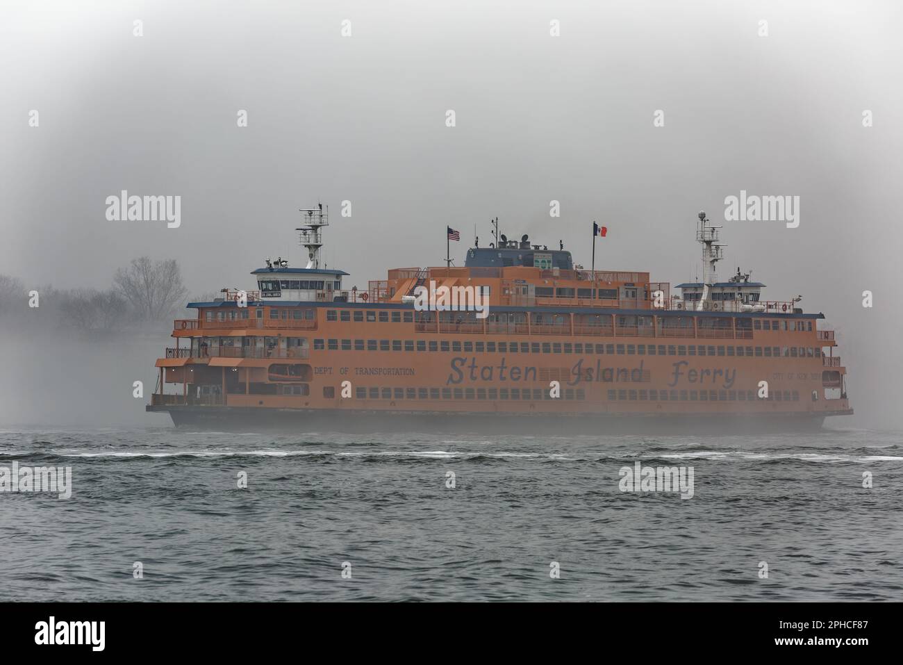 The Staten Island Ferry is the only spot of color on a foggy February