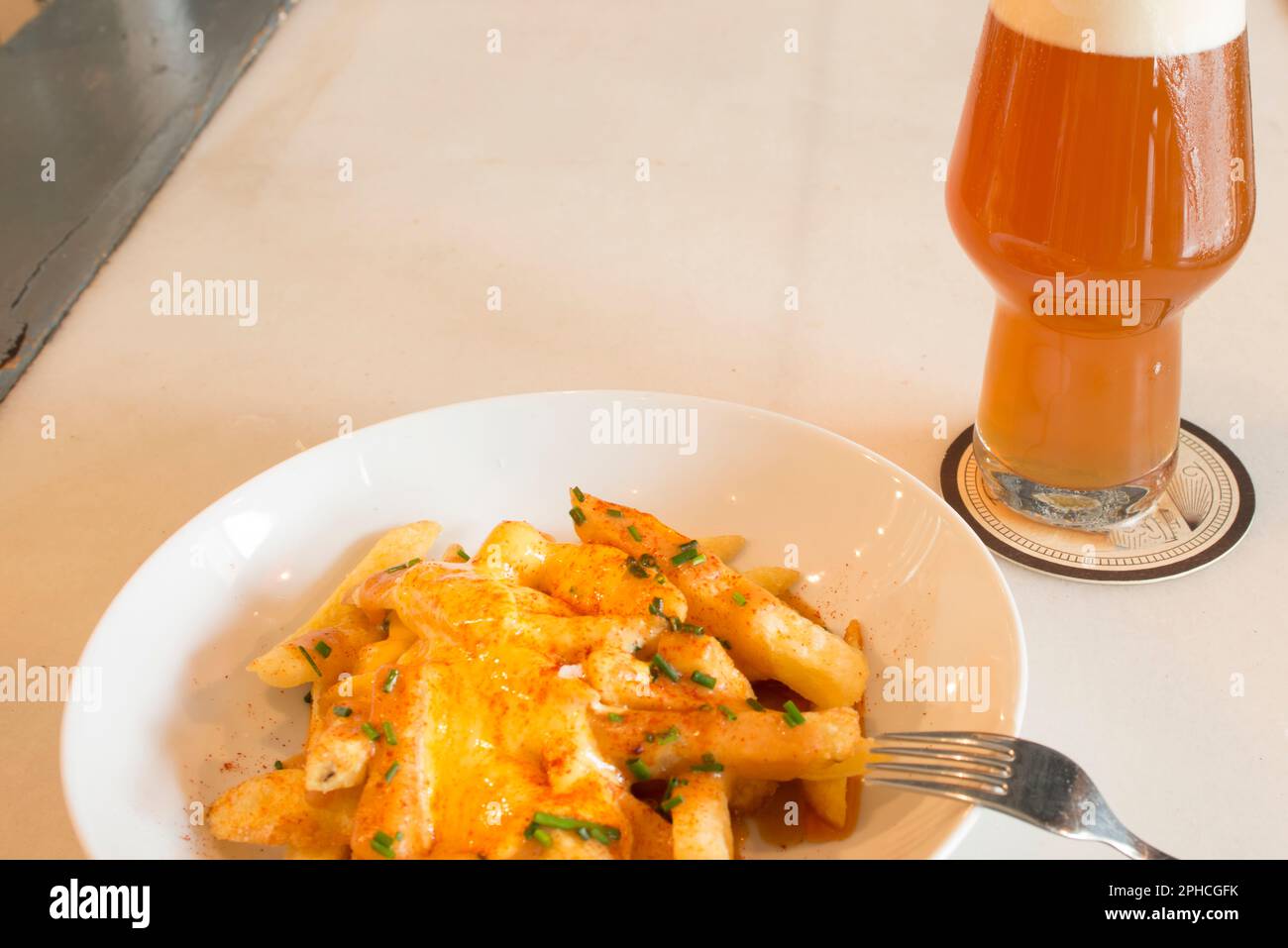 A tapa of chips with cheese and paprika when ordering a beer in a
