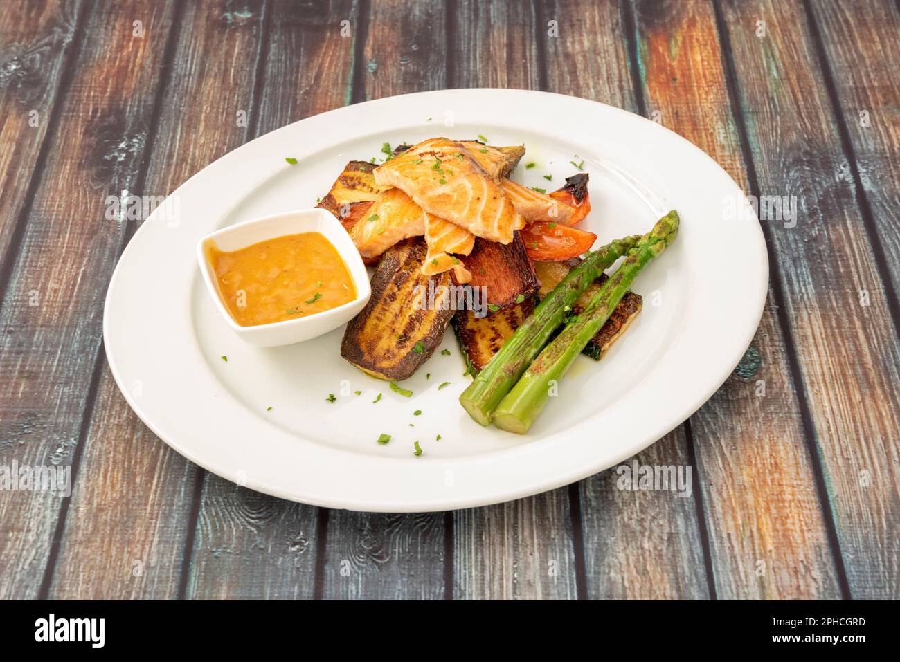 Grilled salmon with sautéed vegetables. An ideal dish to lose weight Stock Photo Alamy