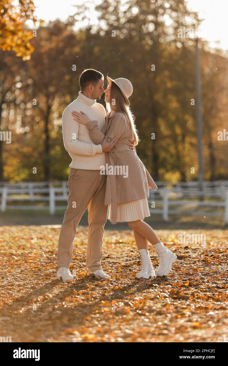 Young stylish couple lovers are hugging and kissing in the autumn ...