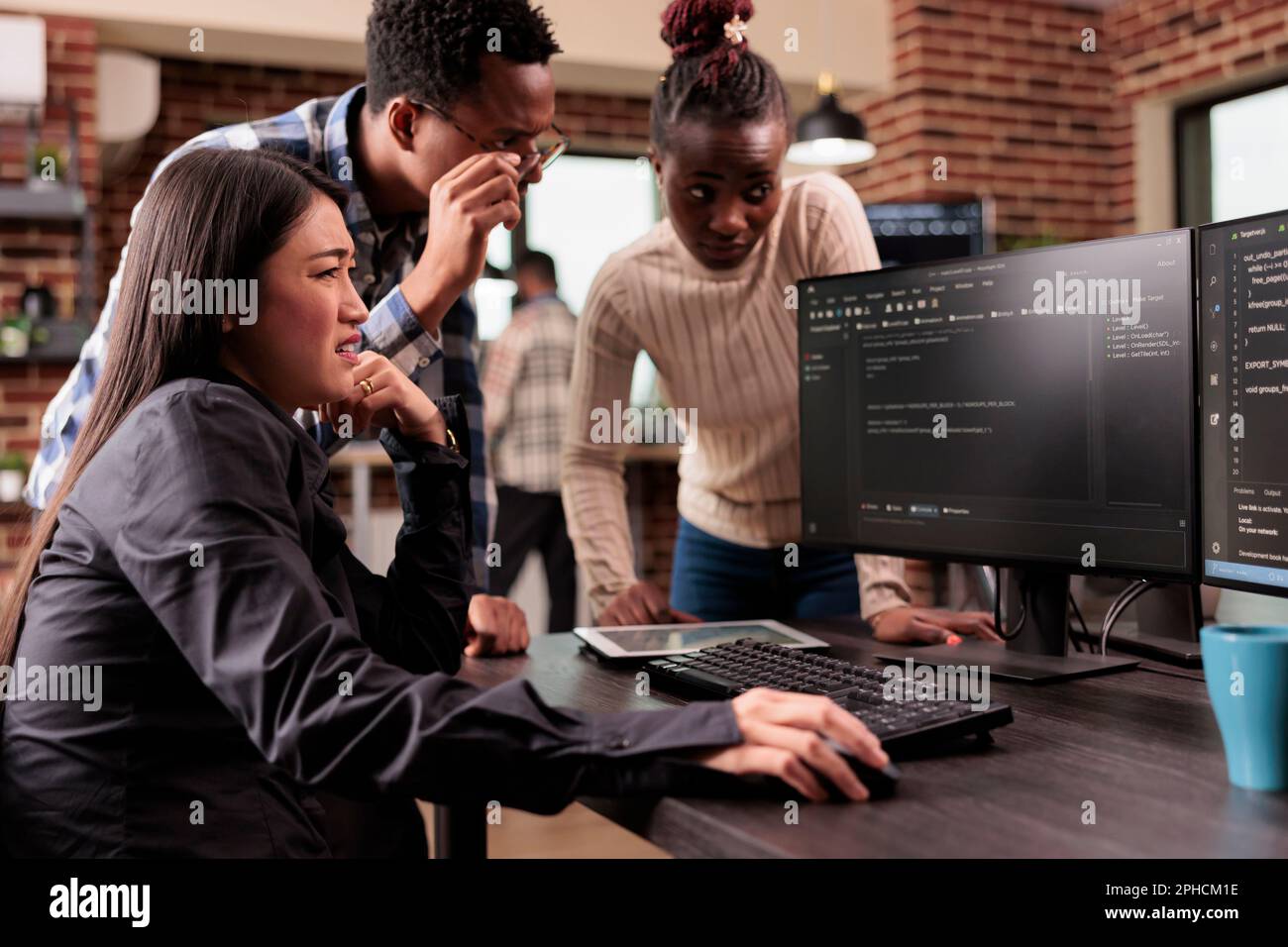 Diverse programming engineers talking about html script, looking at code on computer, working on server interface development. Tech enginners parsing cloud computing project with big data in it agency Stock Photo