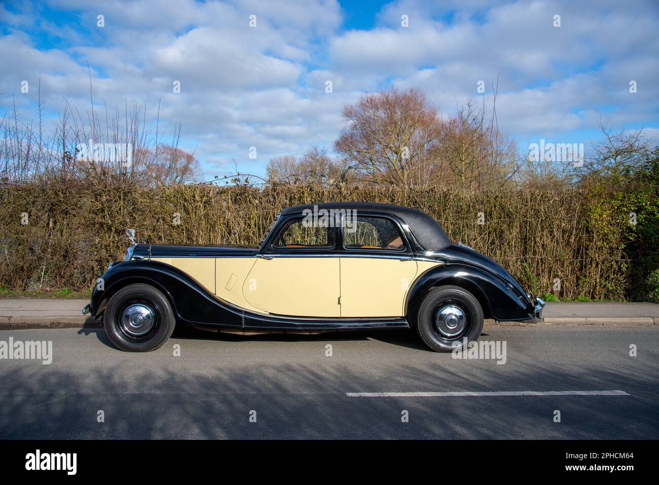 Post war Riley RMB saloon parked on a country road in front of a tall hedge on a sunny Winter day Stock Photo